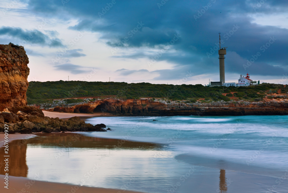Lighthouse of Ponta do Altar under gloomy sunset sky