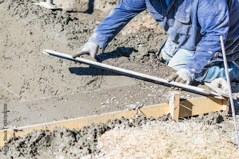 Pool Construction Worker Working With A Smoother Rod On Wet Concrete Pool Construction Worker Working With A Smoother Rod On Wet Concrete
