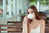 woman drinking Tea Cappuccino in trendy cafe shop