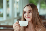 Woman enjoying her cup of tea coffee, hot beverage eyes closed