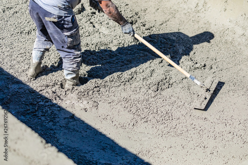 Pool Construction Worker Working With A Bullfloat On Wet Concrete