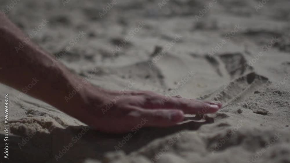 lose up shot on a man hand touching the sand beach. Slow motion real life lose up shot on a man hand touching the sand beach. Slow motion real life