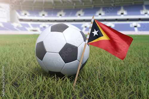 East Timor flag in stadium field with soccer football
