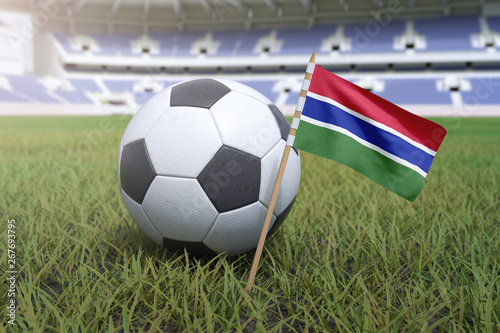 Gambian flag in stadium field with soccer football