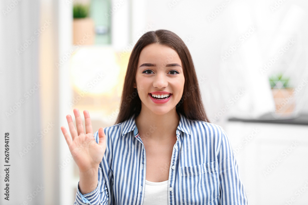 Beautiful woman using video chat for conversation indoors Beautiful woman using video chat for conversation indoors