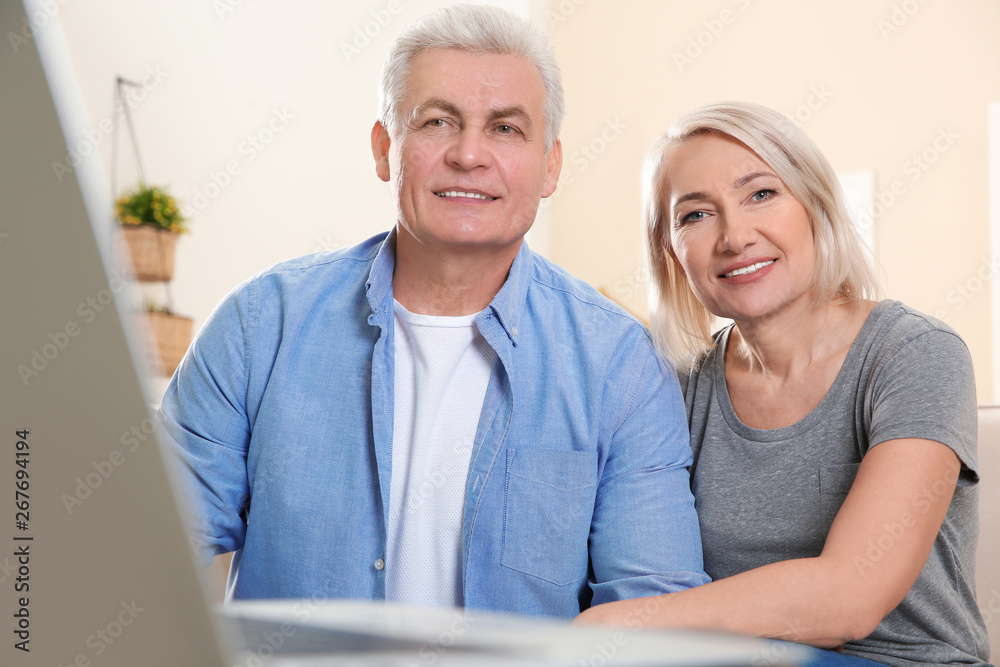 Mature couple using video chat at home Mature couple using video chat at home