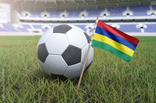 Mauritius flag in stadium field with soccer football
