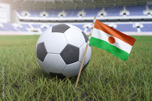 Niger flag in stadium field with soccer football