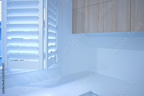 Partly opened bifold plantation shutters. photo