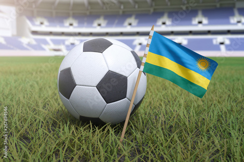 Rwanda flag in stadium field with soccer football
