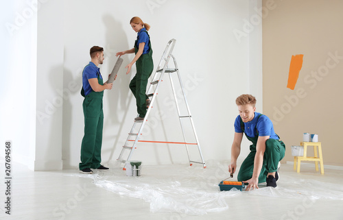 Professional decorators working indoors. Home repair service © New Africa