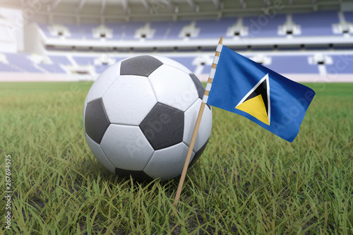 Saint Lucia flag in stadium field with soccer football
