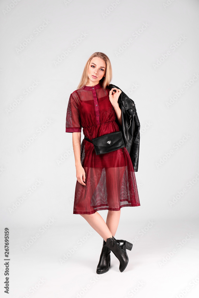 Young stylish woman in trendy shoes with bum bag on light background Young stylish woman in trendy shoes with bum bag on light background