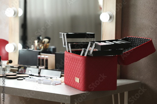 Case with makeup products on dressing table