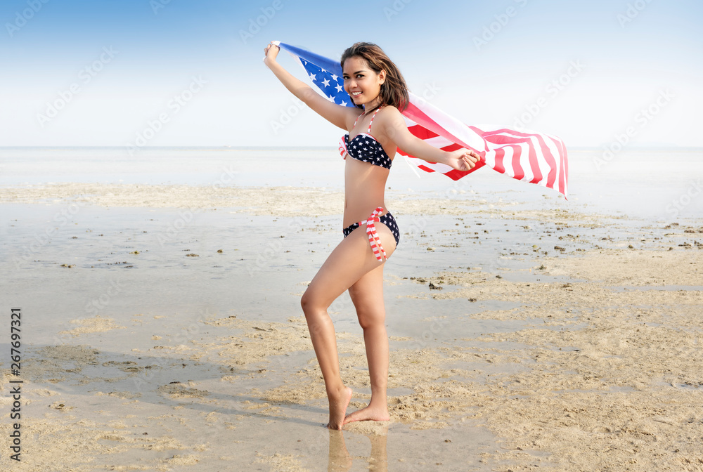 Asian sexy girl in bikini of american flag holding a waving american flag  on the beach foto de Stock | Adobe Stock