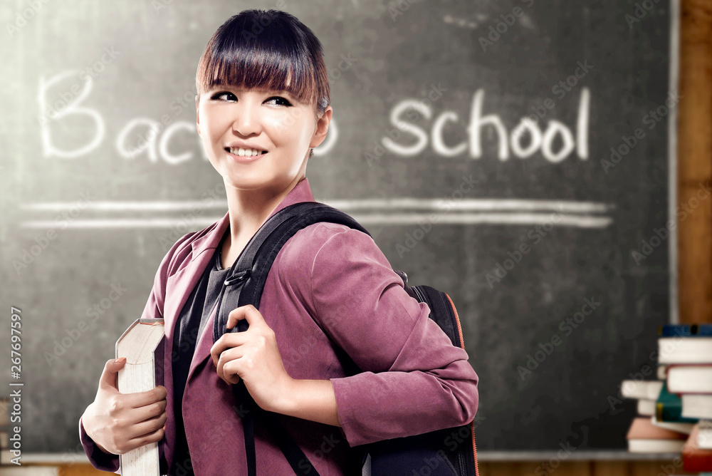 Asian student woman with backpack carrying book standing and look back ...