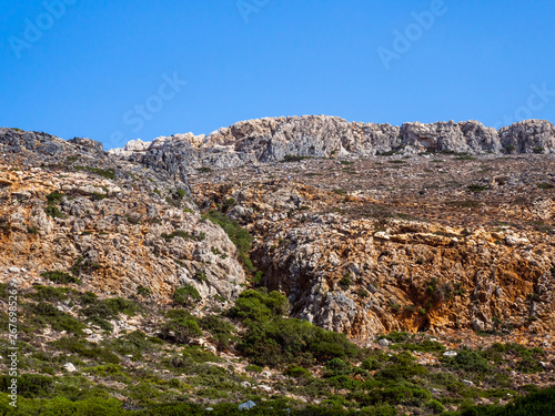 Rock and stone hills with scarce vegetation, bushes and small trees - Greece