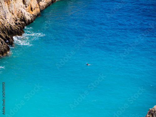 Lone diver in a amazing blue cove - crystal blue sea