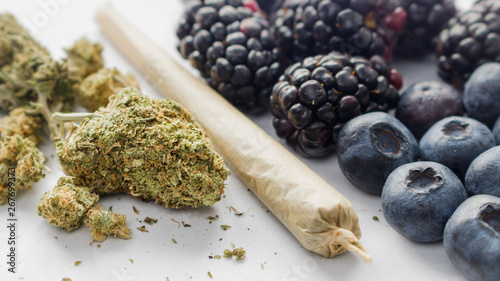 Marijuana Buds, A Rolled Joint & Organic Blackberries & Blueberries On White