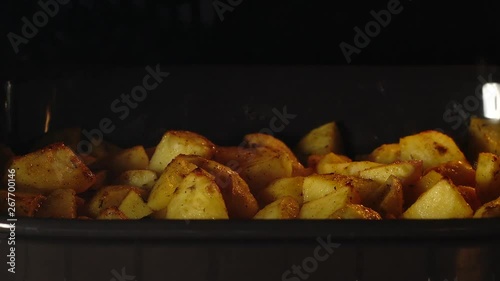 TIME-LAPSE: Close shot of cooking fried potatoes in the oven