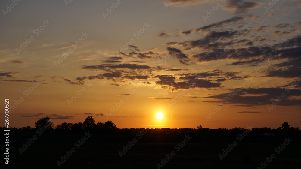 Beautiful Sunset over a field with clouds 