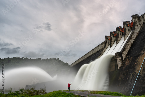 Traveler with a large dam gate. Dam with floodgate photo