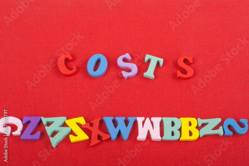 costs word on red background composed from colorful abc alphabet block wooden letters, copy space for ad text. Learning english concept.