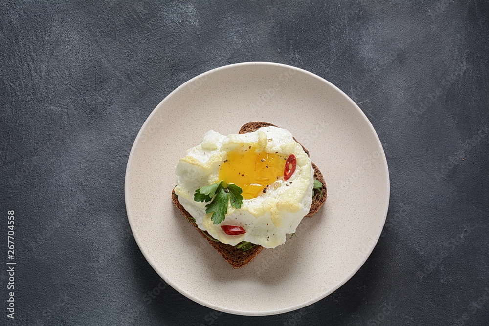 Delicate baked egg. Orsini eggs in the cloud. French breakfast.Cloud egg on toast Delicate baked egg. Orsini eggs in the cloud. French breakfast.Cloud egg on toast