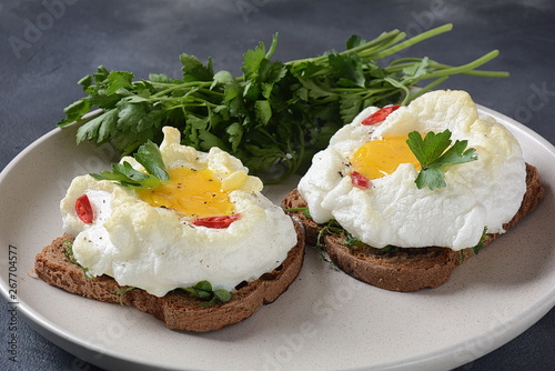 Delicate baked egg. Orsini eggs in the cloud. French breakfast.Cloud egg on toast  photo