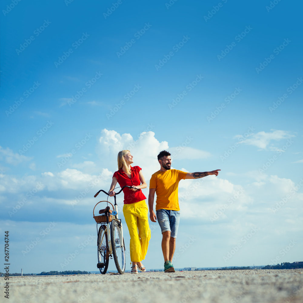 Sexy couple. Married couple and sexual problems concept. Lovers having romantic moments. I love you very much. Summer woman with retro bike on blue sky background
