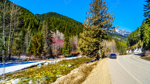 View of the snow capped Coast Mountains along the winding Highway 99, the Duffey Lake Road, as it winds through the Coast Mountain Range between Pemberton and Lillooet in British Columbia, Canada photo