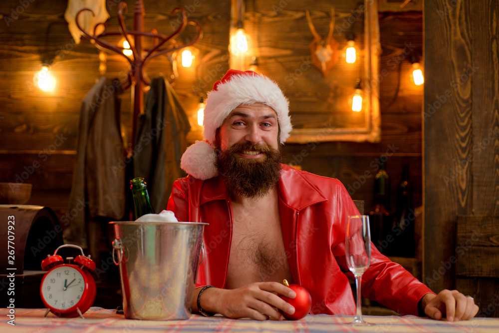 Man bearded hipster santa with red hat celebrate with champagne drink. Christmas holiday. Lonely on christmas eve. Happy new year. Time to drink. Manly brutal santa leather jacket. Brutal santa claus Man bearded hipster santa with red hat celebrate with champagne drink. Christmas holiday. Lonely on christmas eve. Happy new year. Time to drink. Manly brutal santa leather jacket. Brutal santa claus