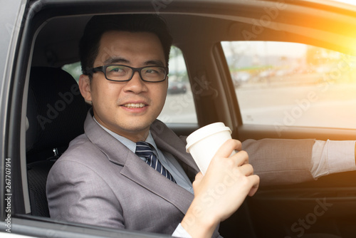 asian business male driving with a coffee © wong yu liang