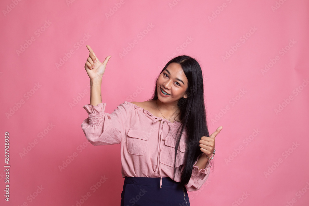 Young Asian woman point and thumbs up. Young Asian woman point and thumbs up.