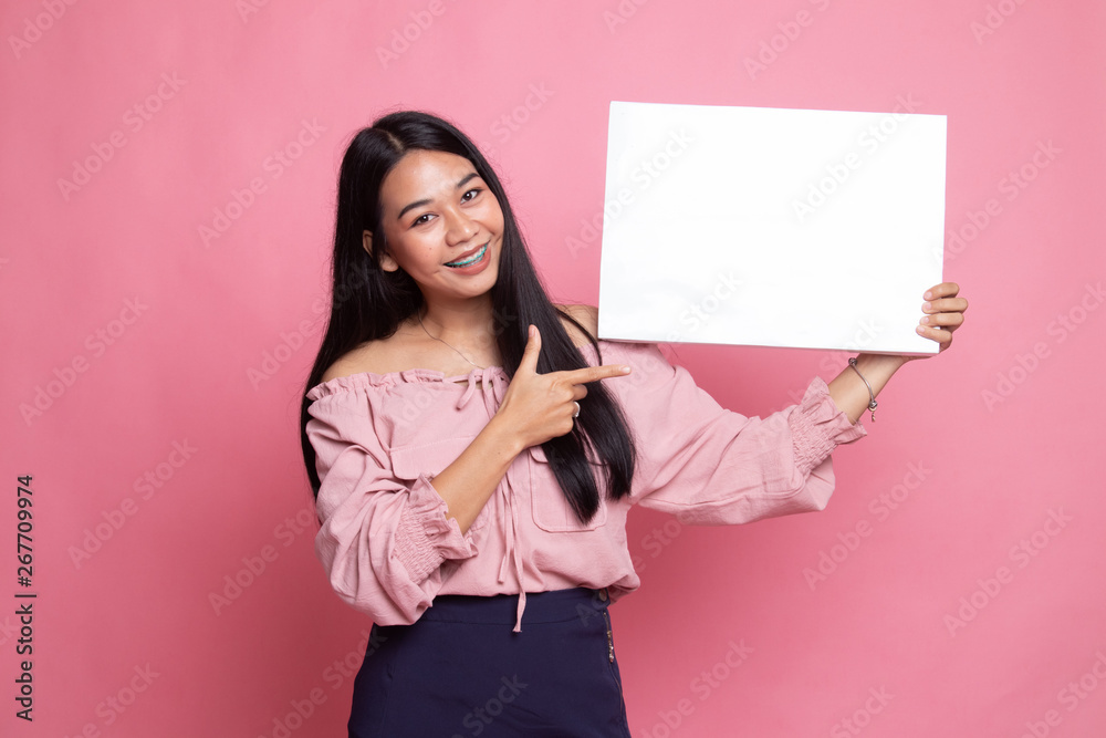 Young Asian woman point to blank sign. Young Asian woman point to blank sign.