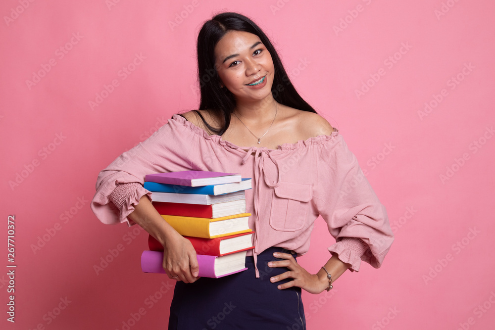 Young Asian woman studying with may books. Young Asian woman studying with may books.