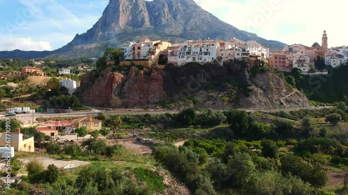 Finestrat is a little village in Spain, close to the Mediterranean sea. Its houses were built on a rock. Behind the village you can see the impressive mountain Puig Campana. photo