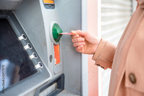 woman hand while using ATM at street