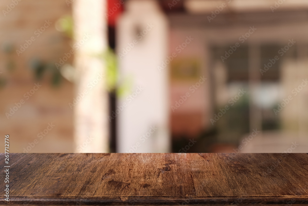 Empty dark wooden table in front of abstract blurred bokeh background of restaurant . can be used for display or montage your products.Mock up for space.