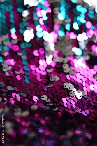 Sequins multicolored blurred bokeh background.Shine fabric sequin. fabric in cold tones.Texture scales close-up.Shiny texture sequin material