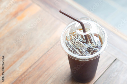 Close up ice of americano on wood table background in coffee shop