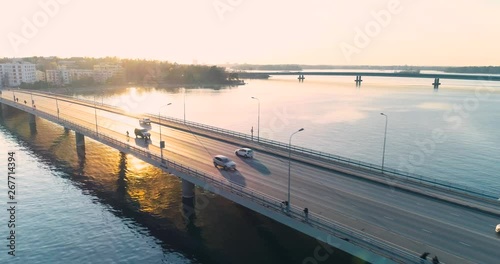 Wallpaper Mural Tracking aerial shot of a bridge in Helsinki during sunset. Cars and cyclists are visible on the bridge. Torontodigital.ca