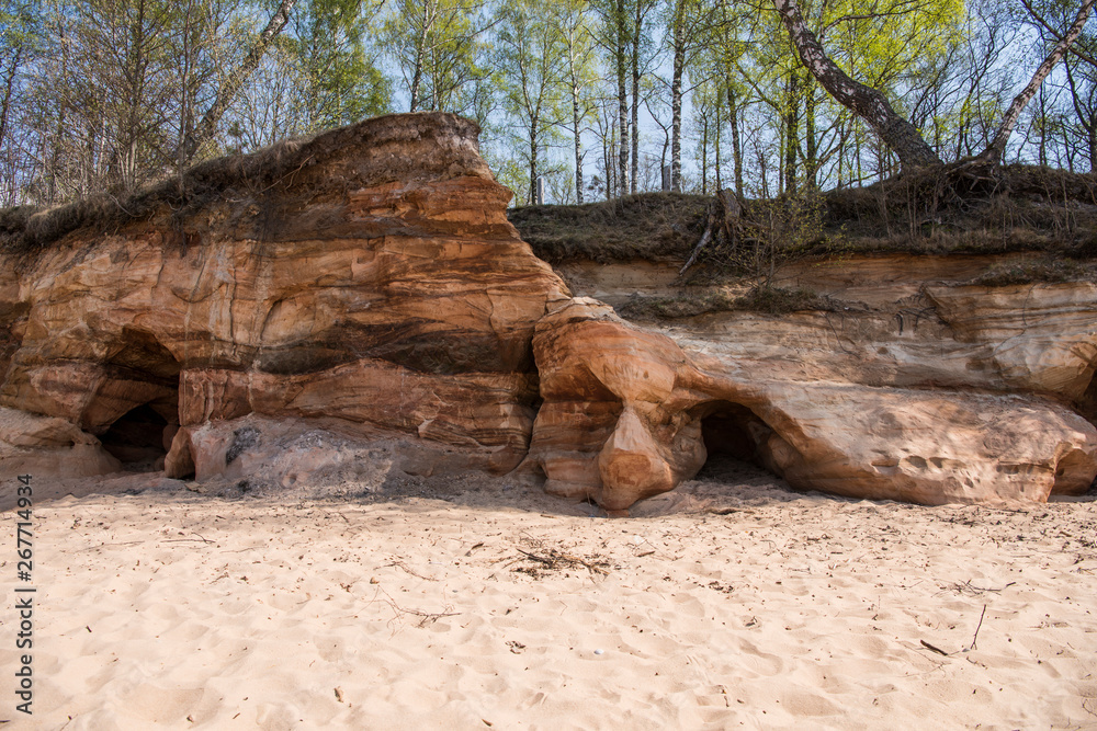 Limestone beach at the Baltic Sea, Latvia with beautiful sand pattern and vivid red and orange color - Veczemju Klintis Limestone beach at the Baltic Sea, Latvia with beautiful sand pattern and vivid red and orange color - Veczemju Klintis