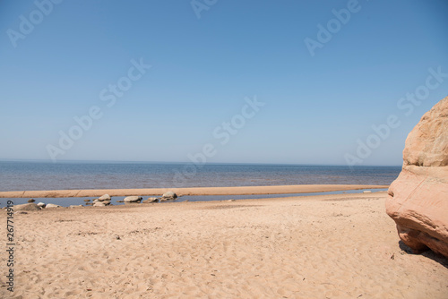 Fototapeta Naklejka Na Ścianę i Meble -  Limestone beach at the Baltic Sea, Latvia with beautiful sand pattern and vivid red and orange color - Veczemju Klintis