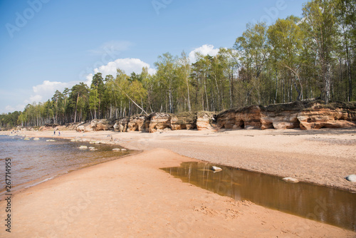 Fototapeta Naklejka Na Ścianę i Meble -  Limestone beach at the Baltic Sea, Latvia with beautiful sand pattern and vivid red and orange color - Veczemju Klintis