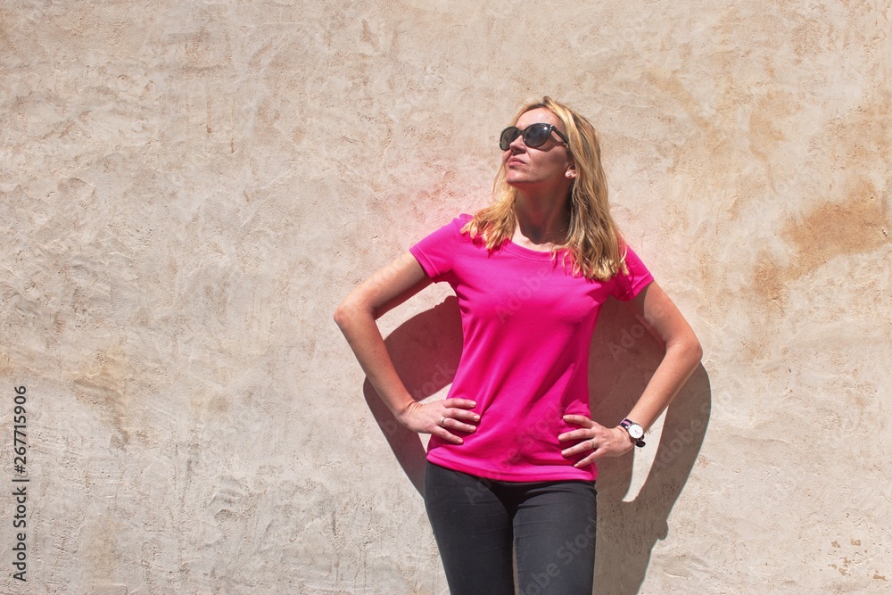 Young woman standing in front of the wall Young woman standing in front of the wall