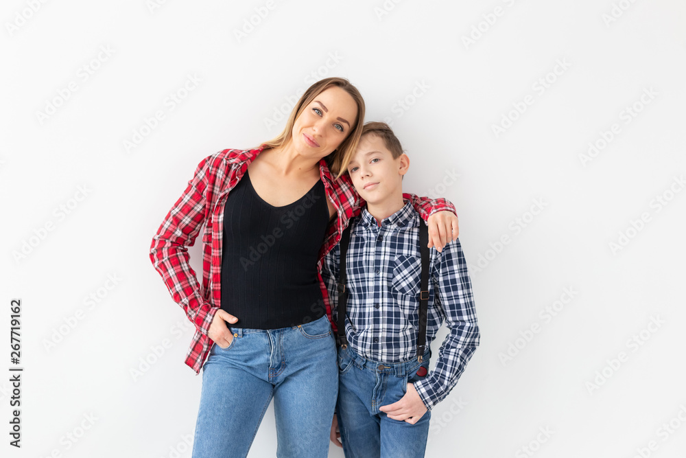 Family, mothers day and teenager concept - Portrait of mother and son on white background Family, mothers day and teenager concept - Portrait of mother and son on white background