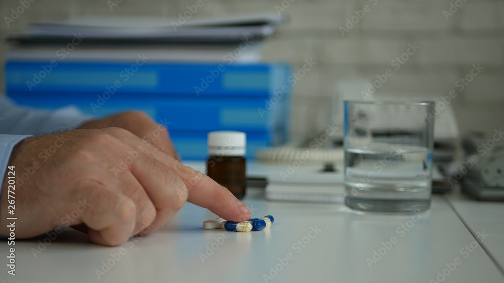 Man Hand Select and Take Pills for a Medical Treatment from the Table