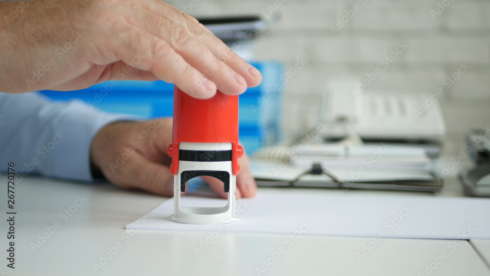 Businessman in Office Room Stamping Official Company Documents and Contracts