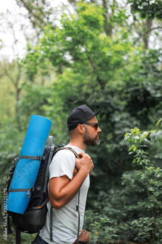 A young guy with a backpack in the cap, traveller in the woods, Hiking, Forest, Journey